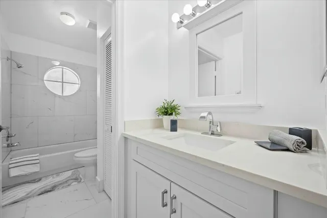 a bathroom with a sink a toilet and vanity