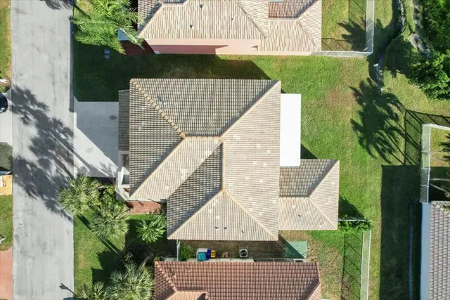 a view of house with backyard and a garden