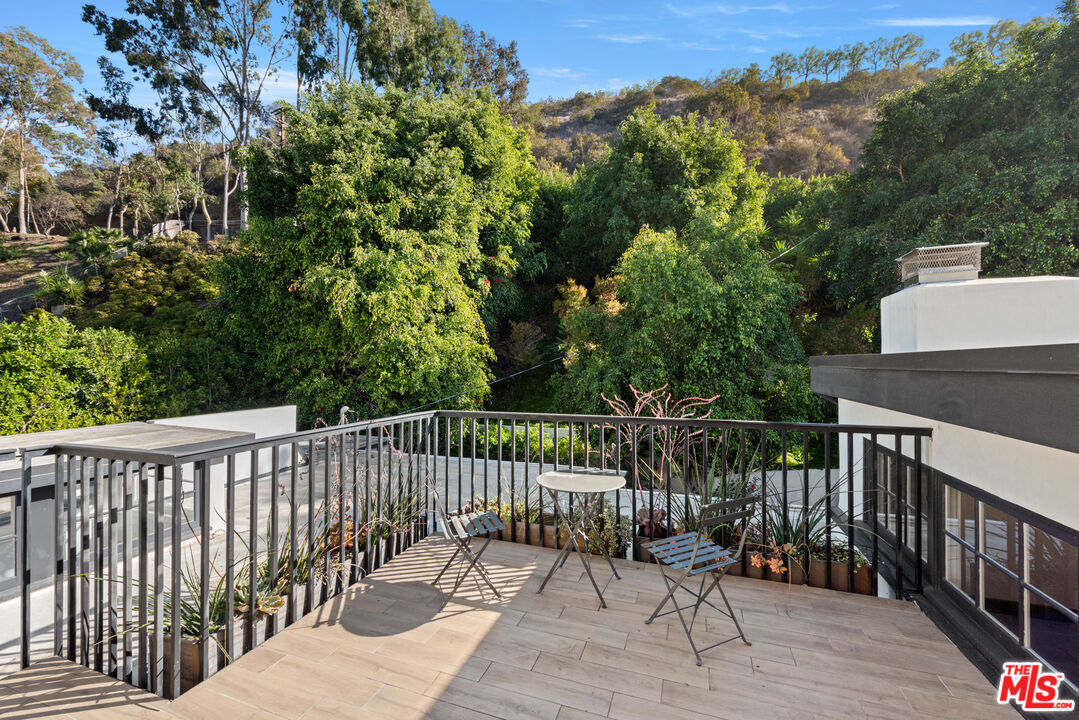 1944 North Beverly Drive Beverly Hills, CA 90210 - Photo 14 of 29 a view of a balcony with wooden floor and fence