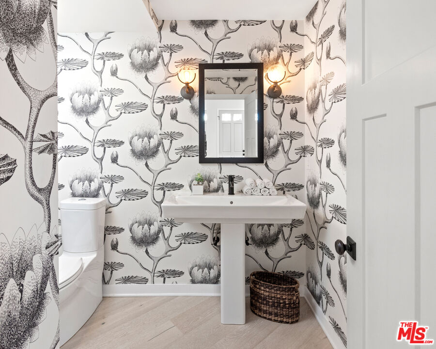 1944 North Beverly Drive Beverly Hills, CA 90210 - Photo 16 of 29 a bathroom with a sink and a mirror