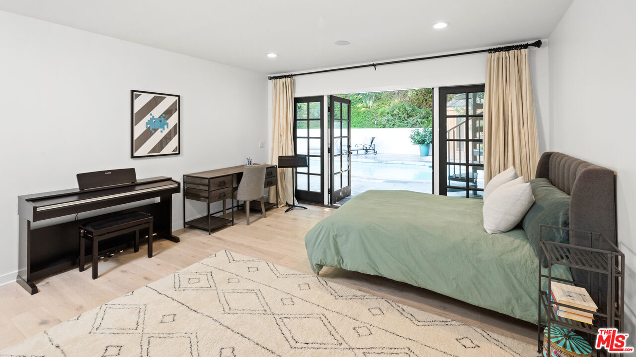 1944 North Beverly Drive Beverly Hills, CA 90210 - Photo 17 of 29 a bedroom with a bed and a desk