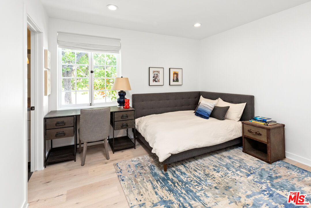 1944 North Beverly Drive Beverly Hills, CA 90210 - Photo 19 of 29 a bedroom with a bed and a table