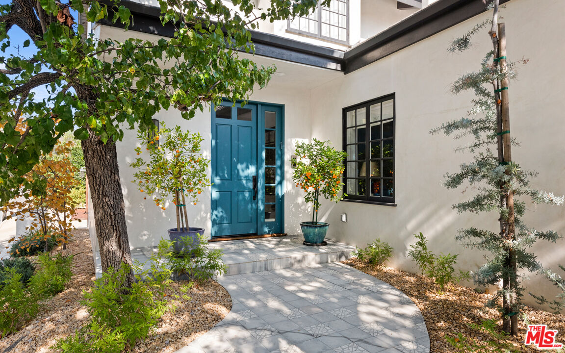 1944 North Beverly Drive Beverly Hills, CA 90210 - Photo 2 of 29 a front view of a house with a tree