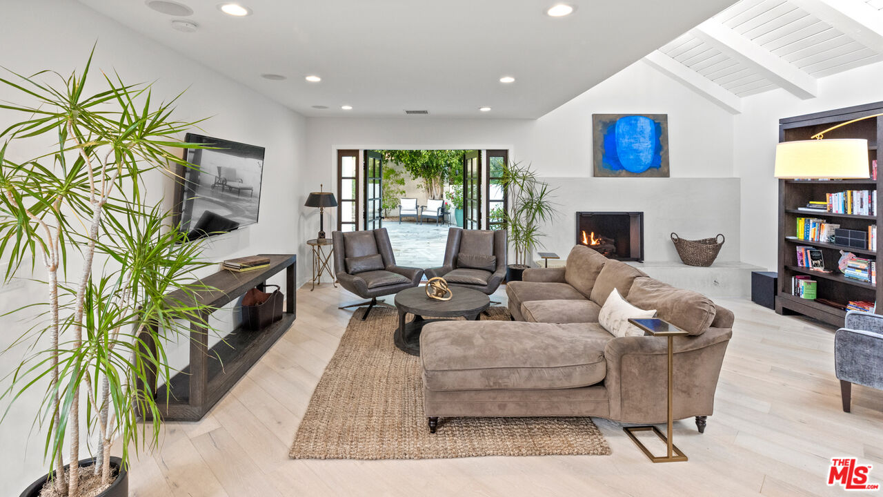 1944 North Beverly Drive Beverly Hills, CA 90210 - Photo 8 of 29 a living room with furniture and a flat screen tv