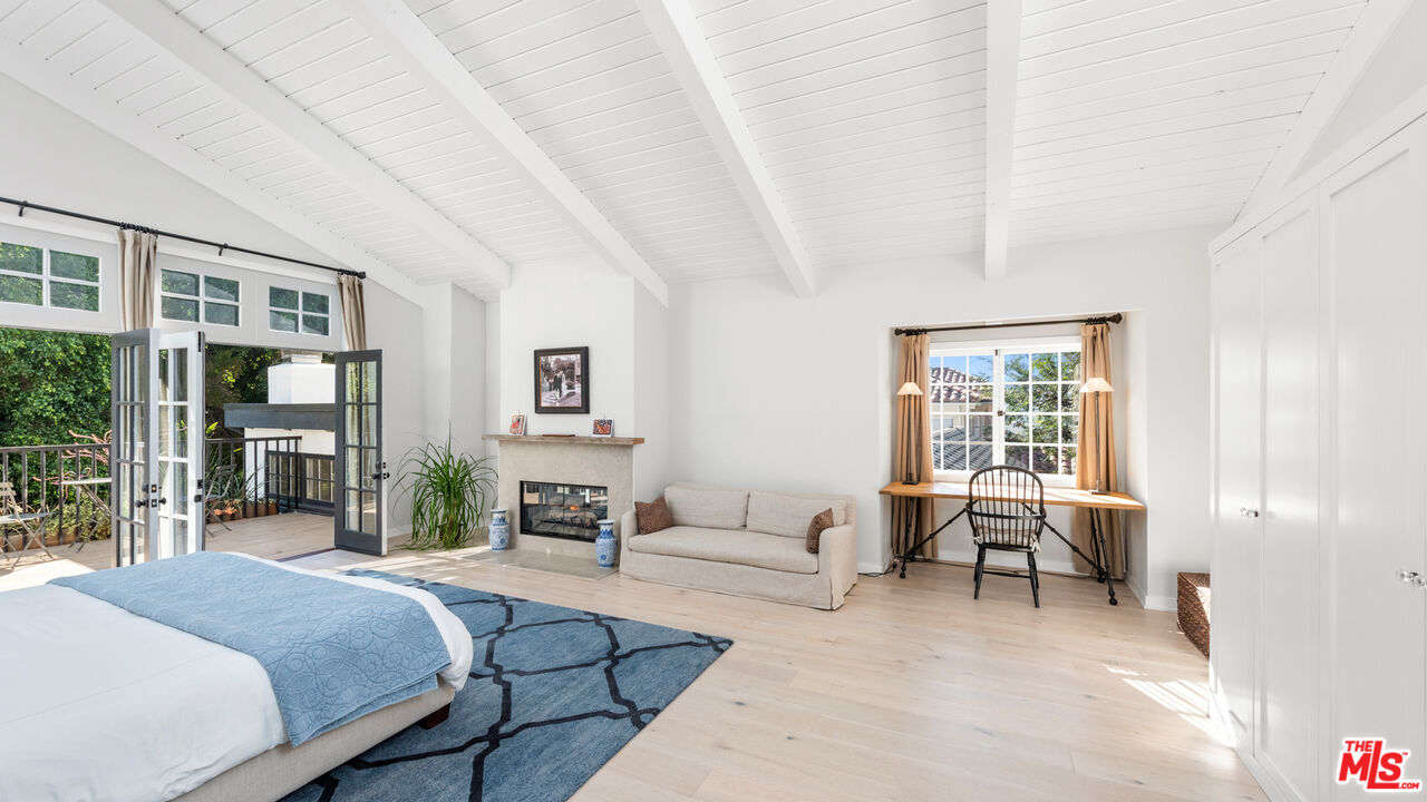 1944 North Beverly Drive Beverly Hills, CA 90210 - Photo 9 of 29 a bedroom with furniture and a fireplace