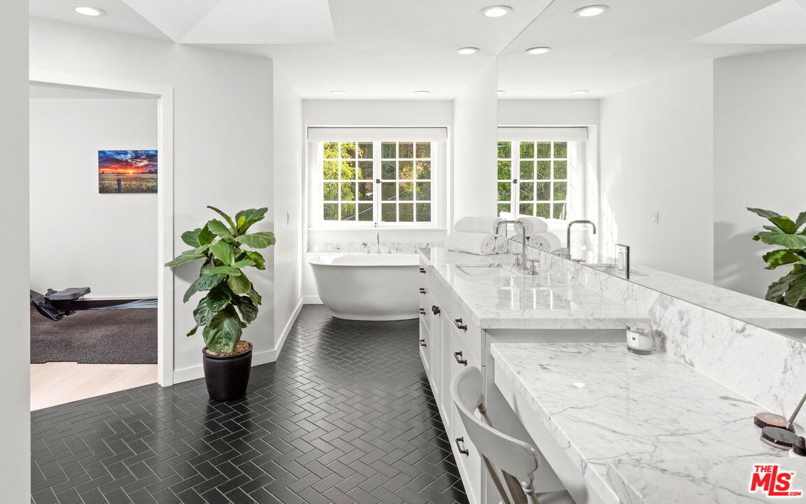 1944 North Beverly Drive Beverly Hills, CA 90210 - Photo 10 of 29 a dining room with furniture and potted plants
