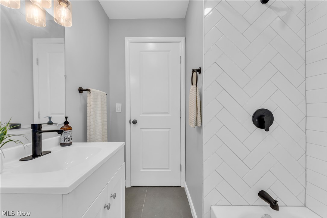 5581 Dunham Road Maple Heights, OH 44137 - Photo 22 of 33 Bathroom featuring tiled shower / bath, oversized vanity, and tile floors