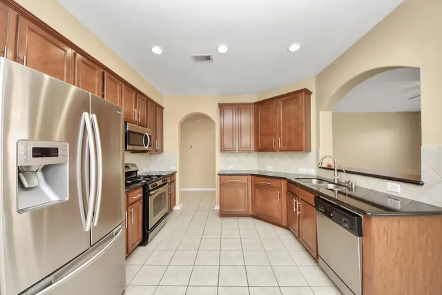 a kitchen with a refrigerator stove and microwave
