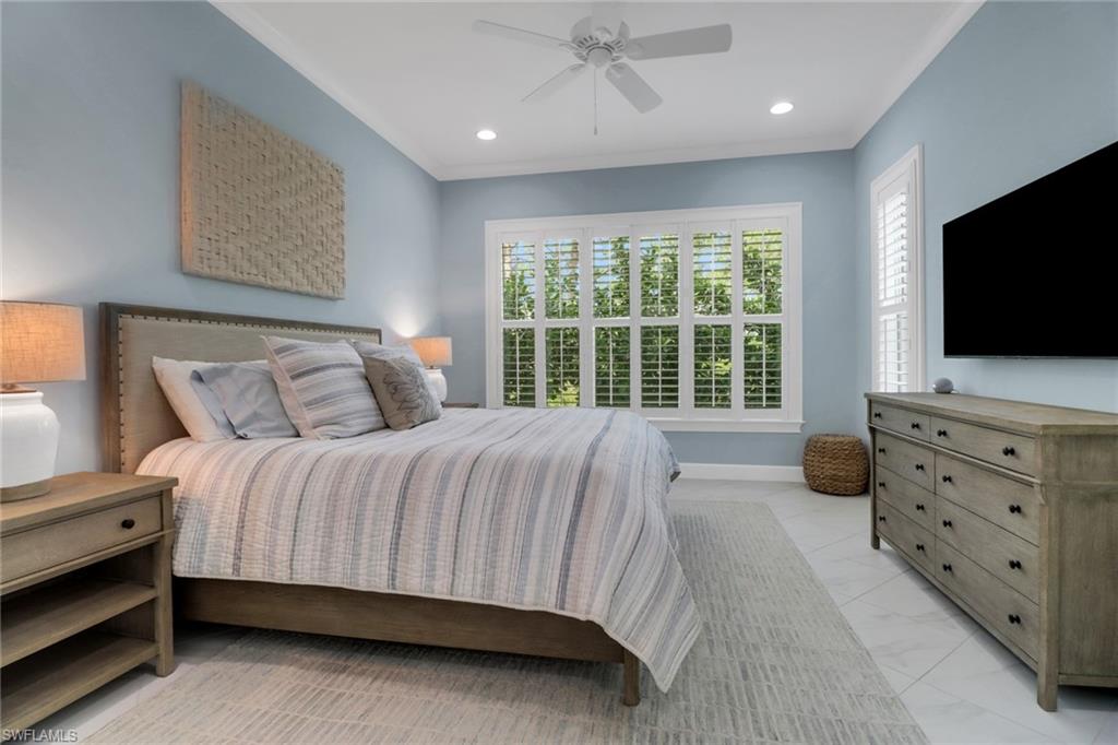 6509 Dominica Drive, Unit 101 Naples, FL 34113 - Photo 13 of 33 a bedroom with a bed and flat tv screen on the dresser