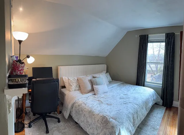 a bedroom with furniture and a window
