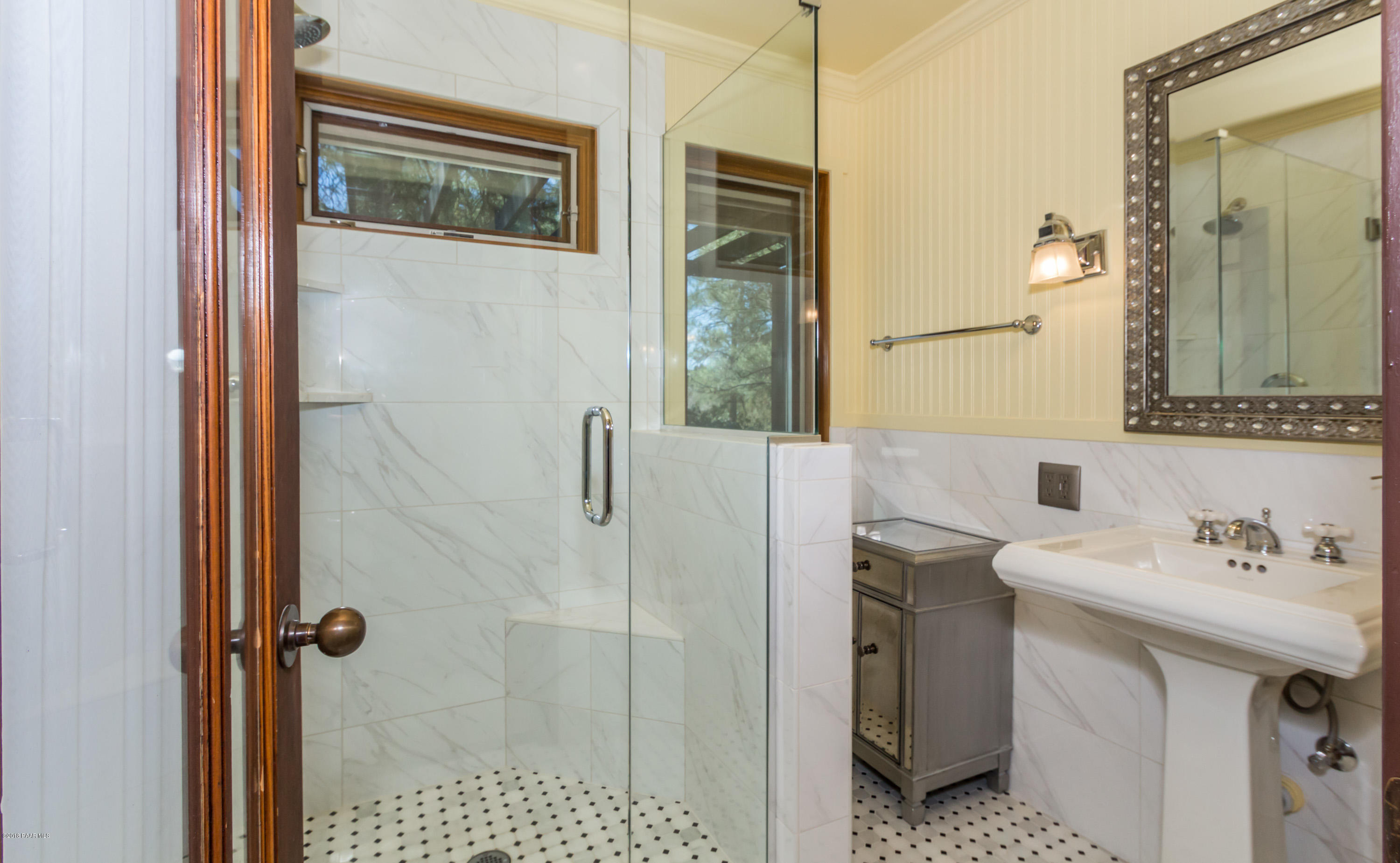 1261 Tanglewood Road Prescott, AZ 86303 - Photo 12 of 36 a bathroom with a sink a mirror a vanity and a shower