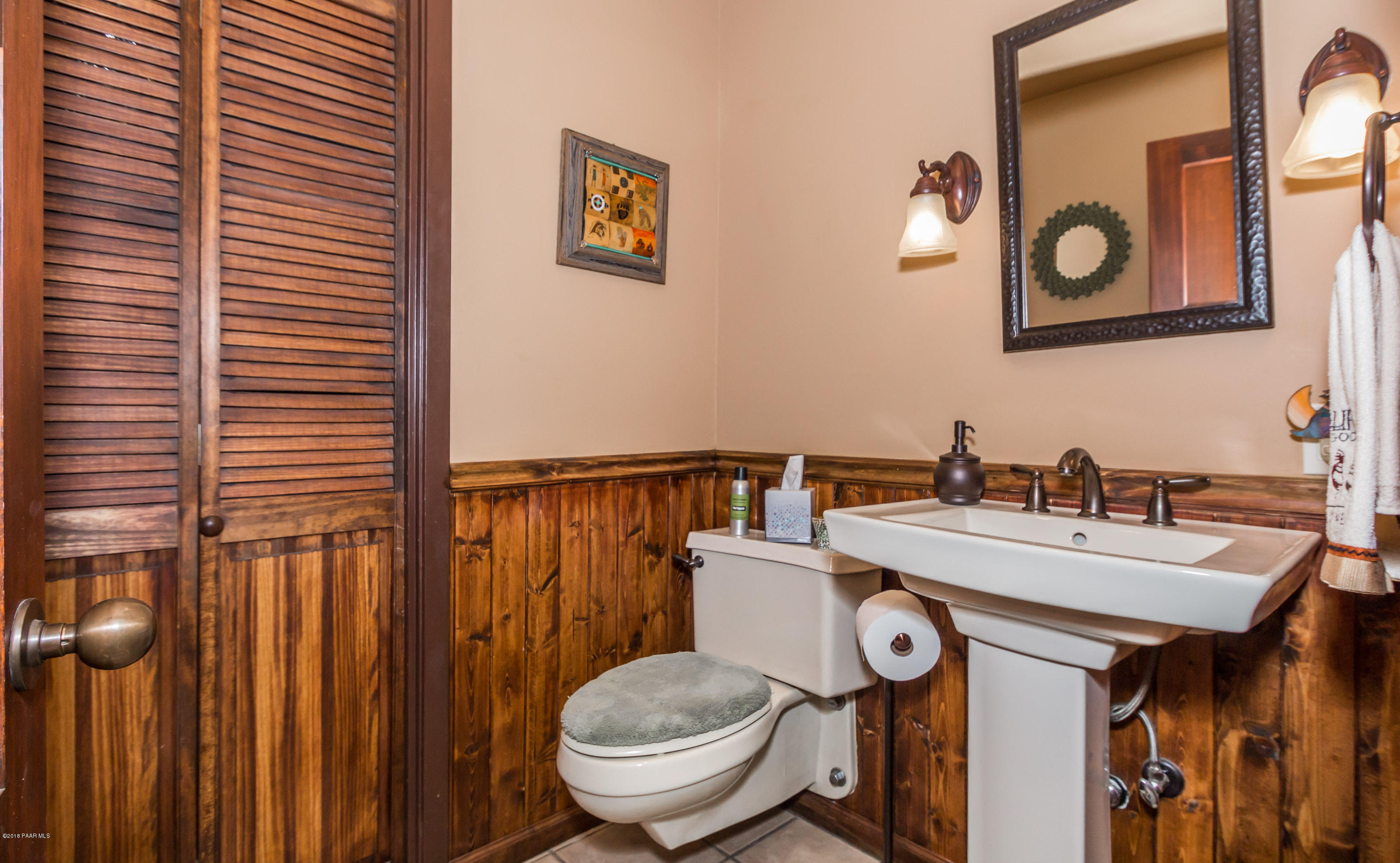 1261 Tanglewood Road Prescott, AZ 86303 - Photo 21 of 36 a bathroom with a toilet a sink and a mirror
