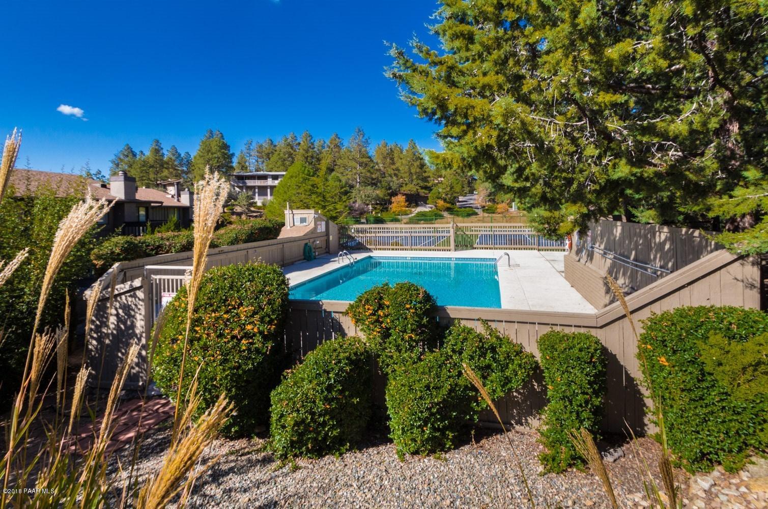 1261 Tanglewood Road Prescott, AZ 86303 - Photo 25 of 36 a view of a yard with plants and large trees