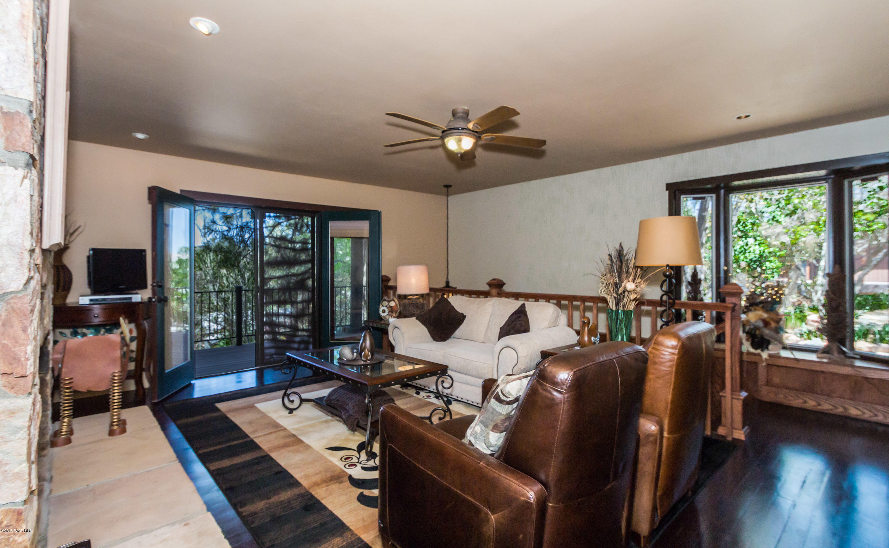 1261 Tanglewood Road Prescott, AZ 86303 - Photo 9 of 36 a living room with furniture fireplace and a large window