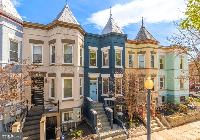 a view of a brick house with many windows