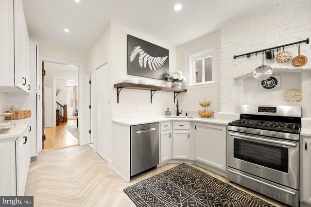 a kitchen with stainless steel appliances granite countertop a stove and cabinets