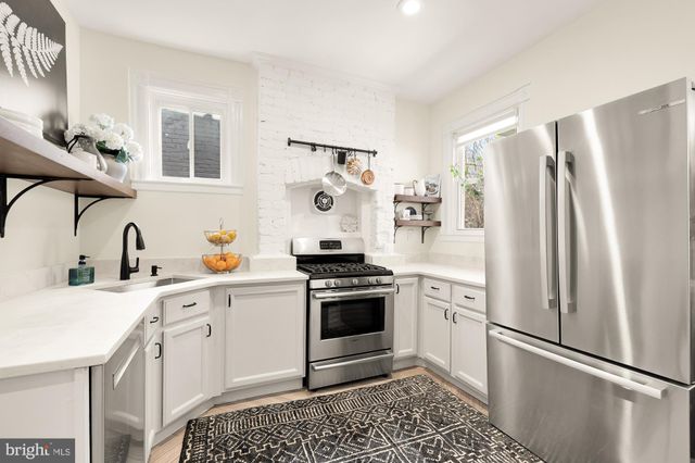 a kitchen with a refrigerator stove and sink