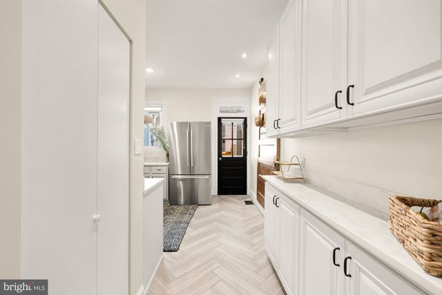 a kitchen with stainless steel appliances a refrigerator and a sink
