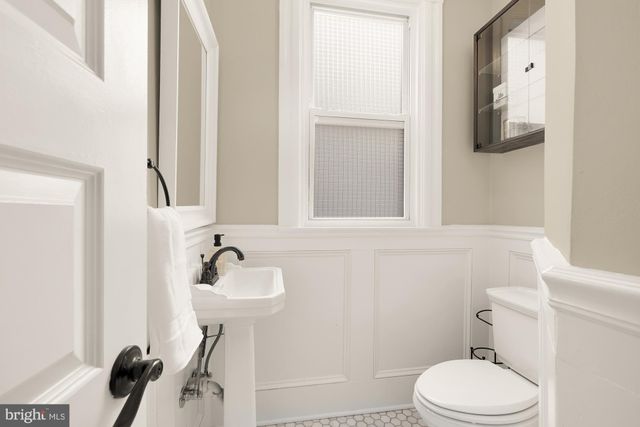 a bathroom with a sink a toilet and mirror