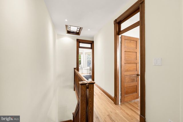a view of a hallway with a large window and stairs