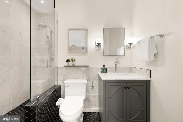a bathroom with a toilet a sink and mirror