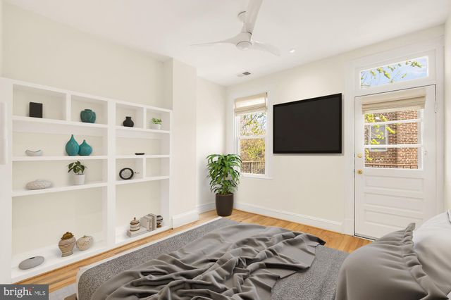 a bedroom with a bed and a flat tv screen