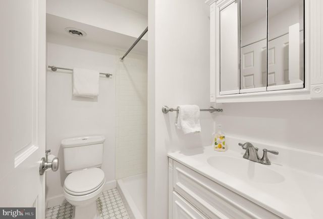 a bathroom with a sink a toilet and a mirror