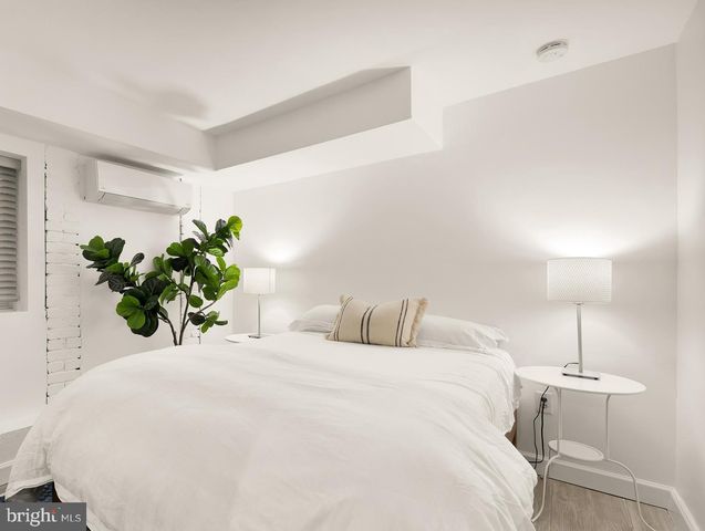 a bedroom with a bed and a lamp