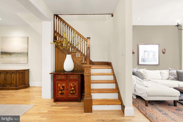 a view of entryway livingroom and hall with wooden floor