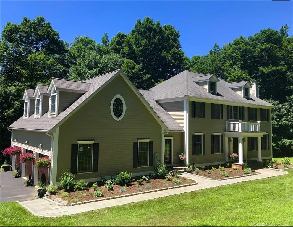 a front view of house with yard and green space