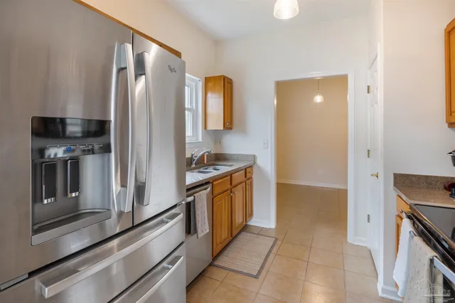 a kitchen with stainless steel appliances granite countertop a refrigerator and a stove