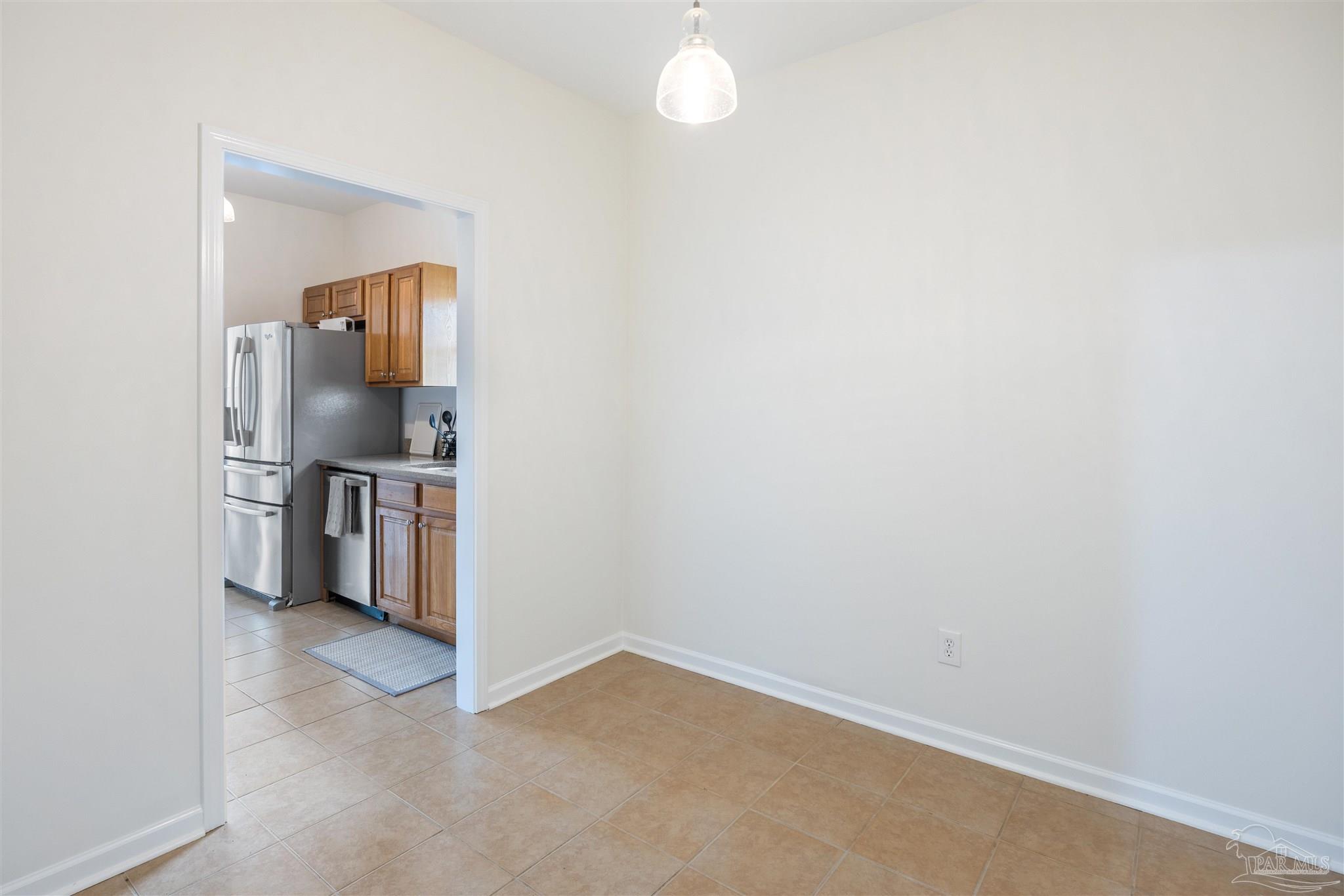6887 Crimson Ridge Street Gulf Shores, AL 36542 - Photo 15 of 37 a view of a kitchen with refrigerator and stove