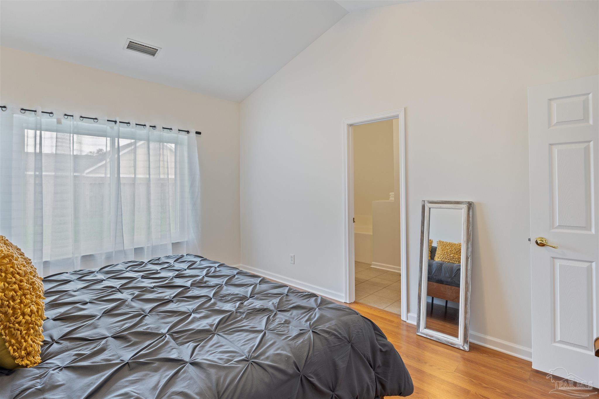 6887 Crimson Ridge Street Gulf Shores, AL 36542 - Photo 16 of 37 a bedroom with a bed and a window