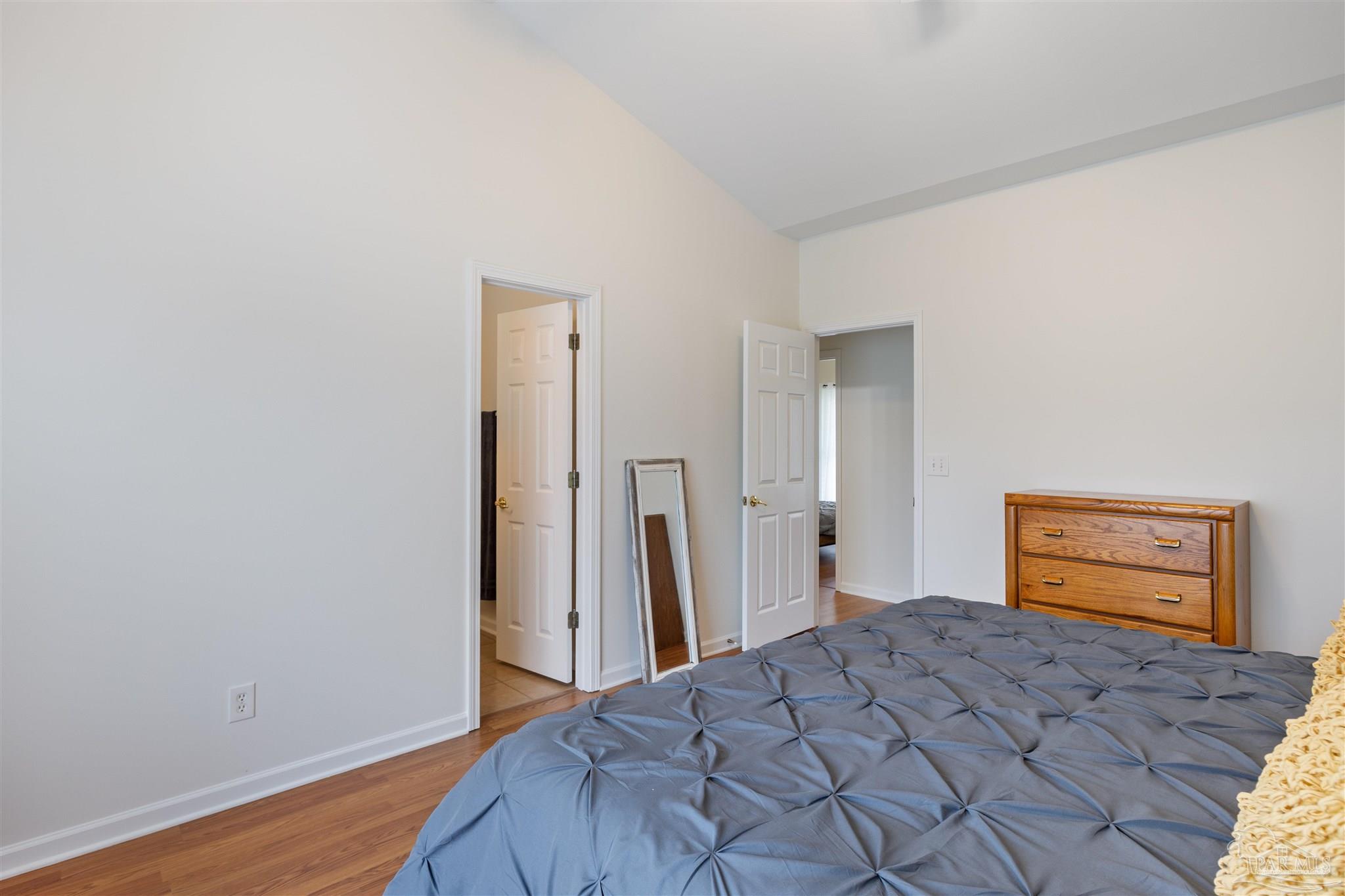 6887 Crimson Ridge Street Gulf Shores, AL 36542 - Photo 19 of 37 a bedroom with a bed and a closet