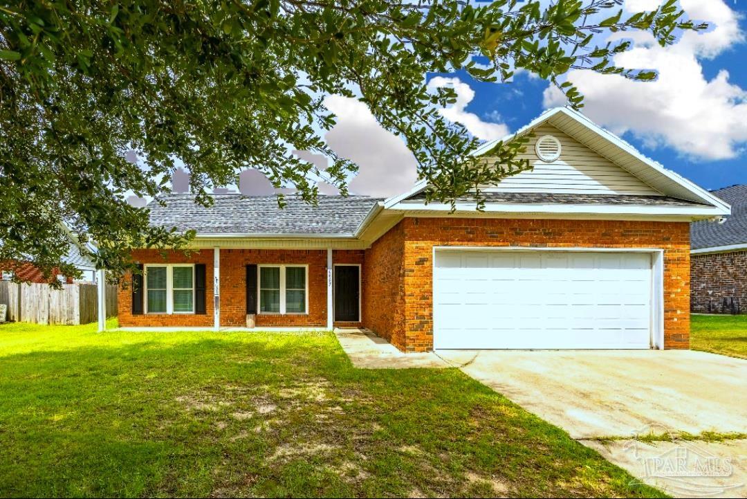 6887 Crimson Ridge Street Gulf Shores, AL 36542 - Photo 2 of 37 a front view of a house with a garden and trees