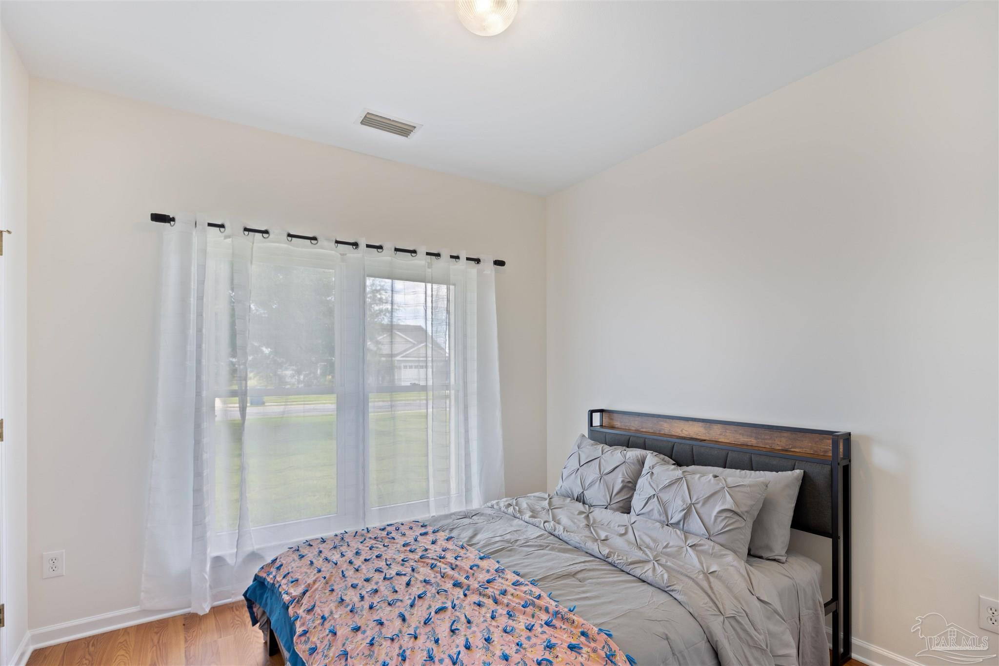 6887 Crimson Ridge Street Gulf Shores, AL 36542 - Photo 22 of 37 a bedroom with a bed and a window