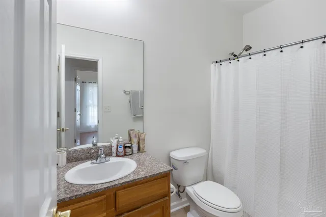 a bathroom with a sink vanity granite and a mirror