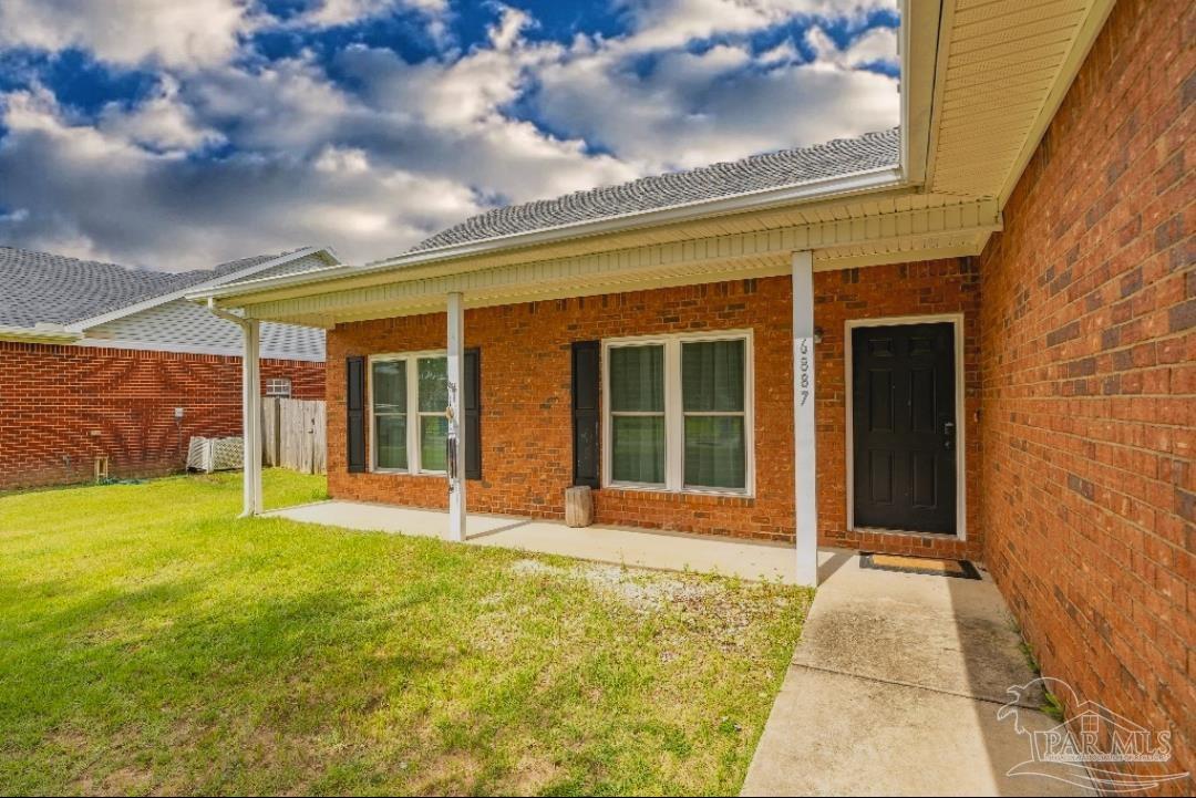 6887 Crimson Ridge Street Gulf Shores, AL 36542 - Photo 34 of 37 a view of a brick house with a large window