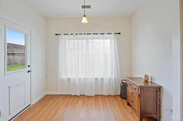 a view of a room with wooden floor closet and windows