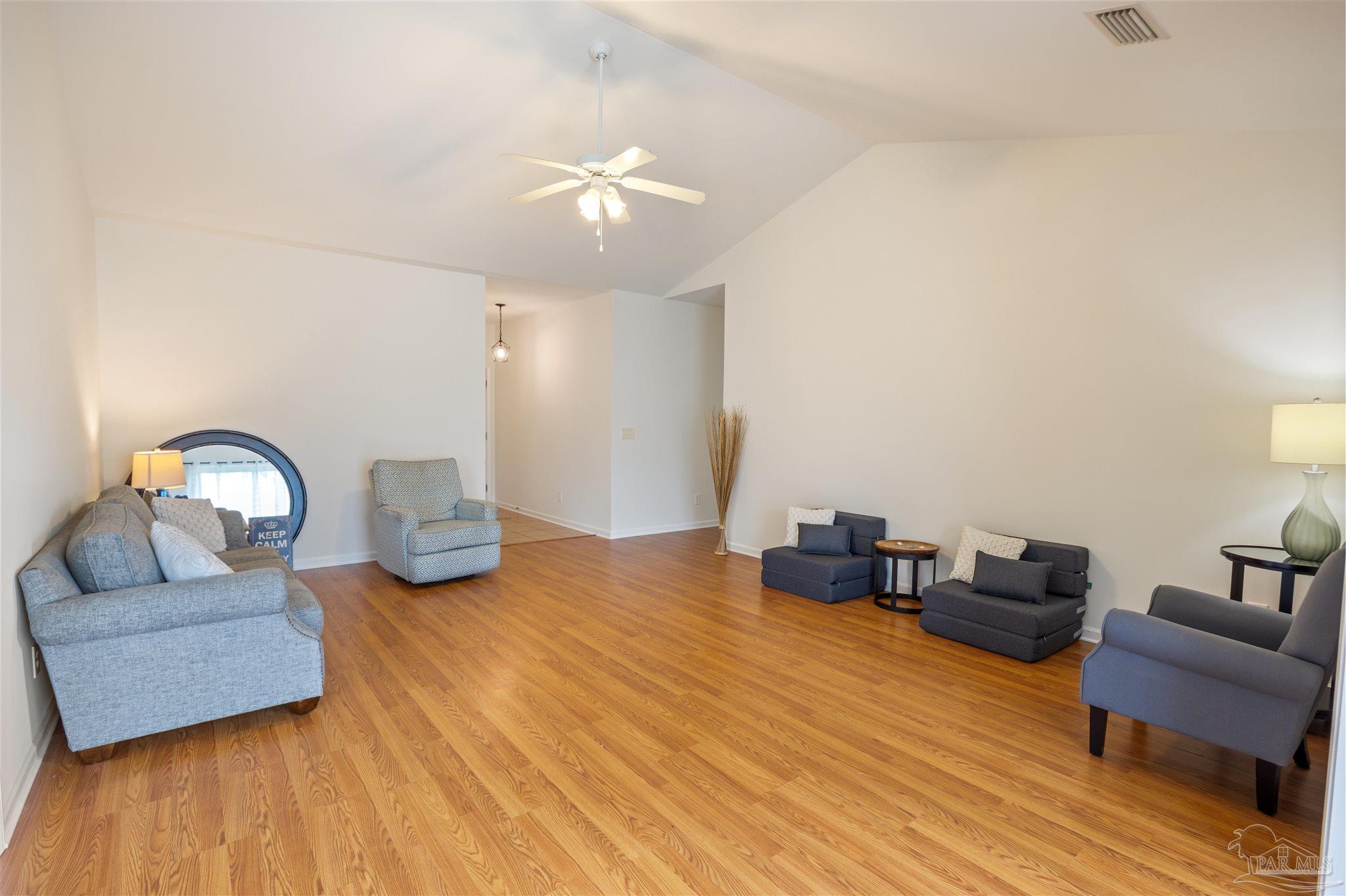 6887 Crimson Ridge Street Gulf Shores, AL 36542 - Photo 6 of 37 a living room with furniture and wooden floor