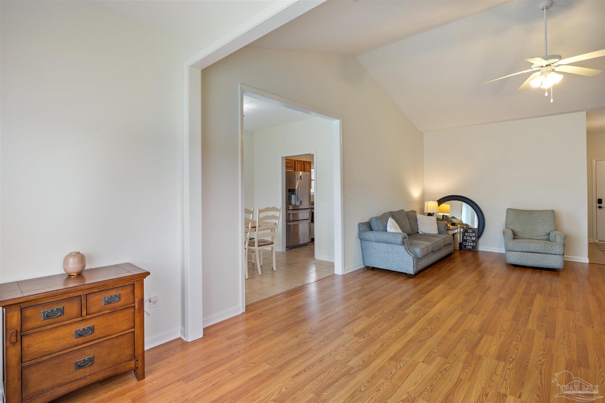 6887 Crimson Ridge Street Gulf Shores, AL 36542 - Photo 7 of 37 a living room with furniture and a wooden floor