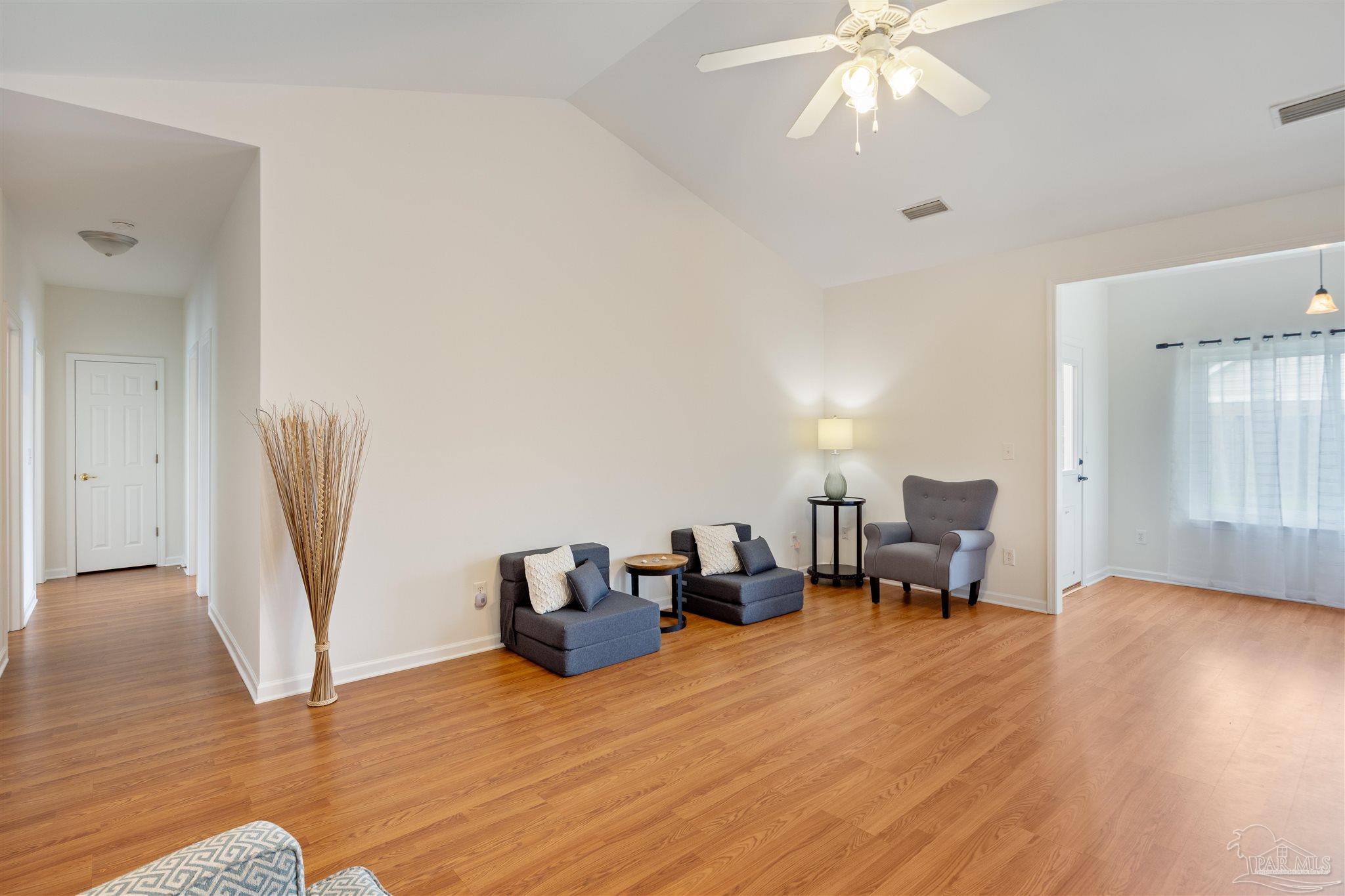 6887 Crimson Ridge Street Gulf Shores, AL 36542 - Photo 8 of 37 a living room with furniture and a wooden floor