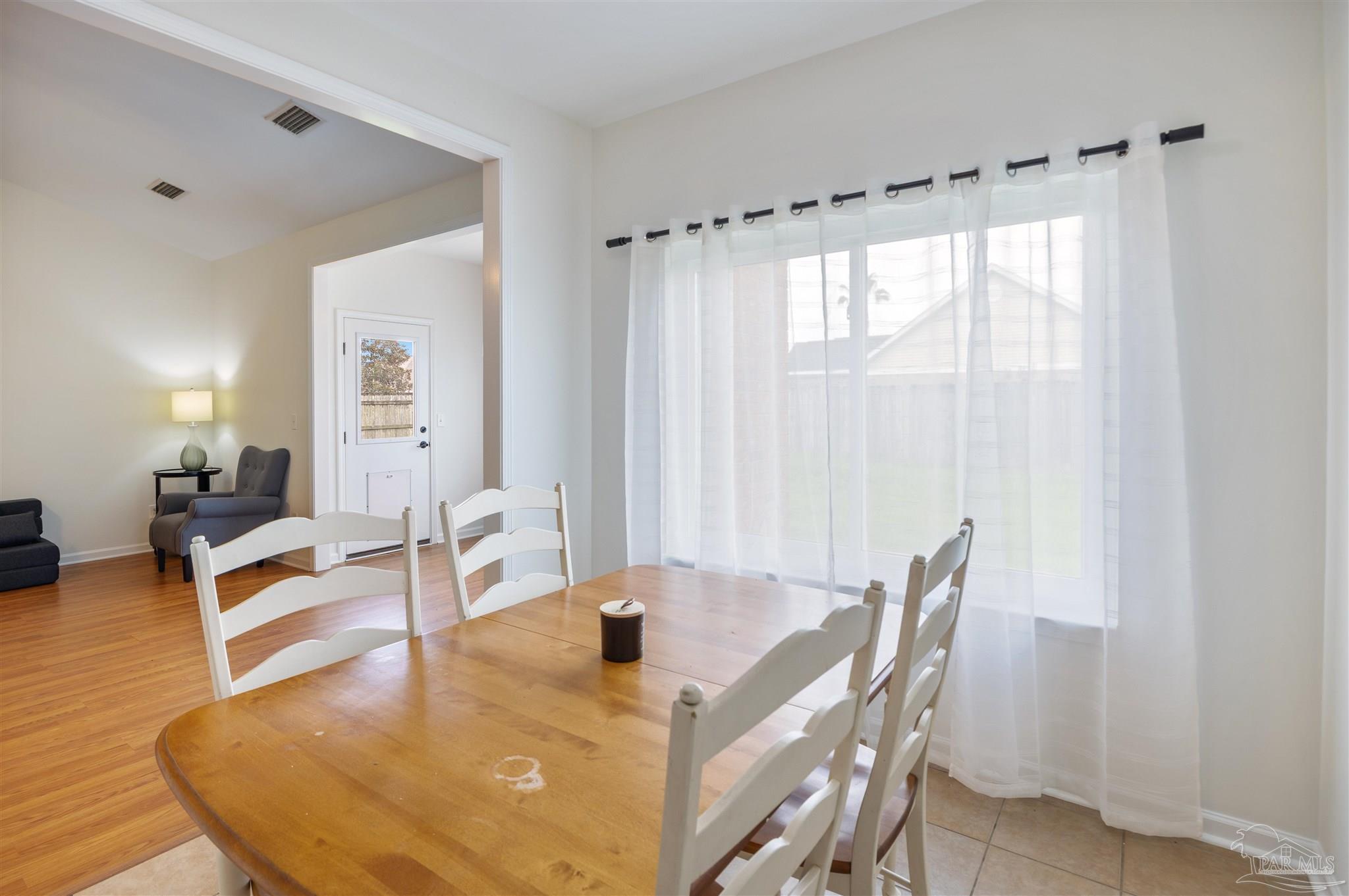 6887 Crimson Ridge Street Gulf Shores, AL 36542 - Photo 10 of 37 a dining room with furniture and wooden floor