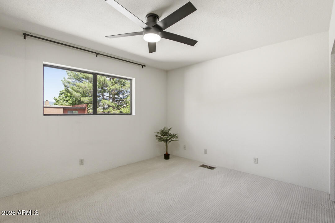 165 Verde Valley School Road, Unit 6 Sedona, AZ 86351 - Photo 32 of 40 an empty room with a ceiling fan and window