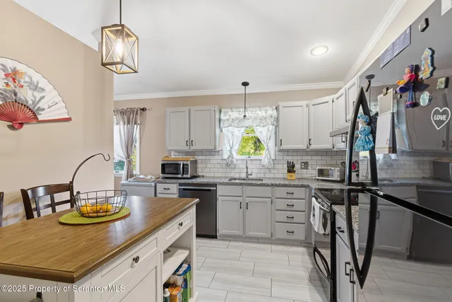 a kitchen with a sink a stove and chairs