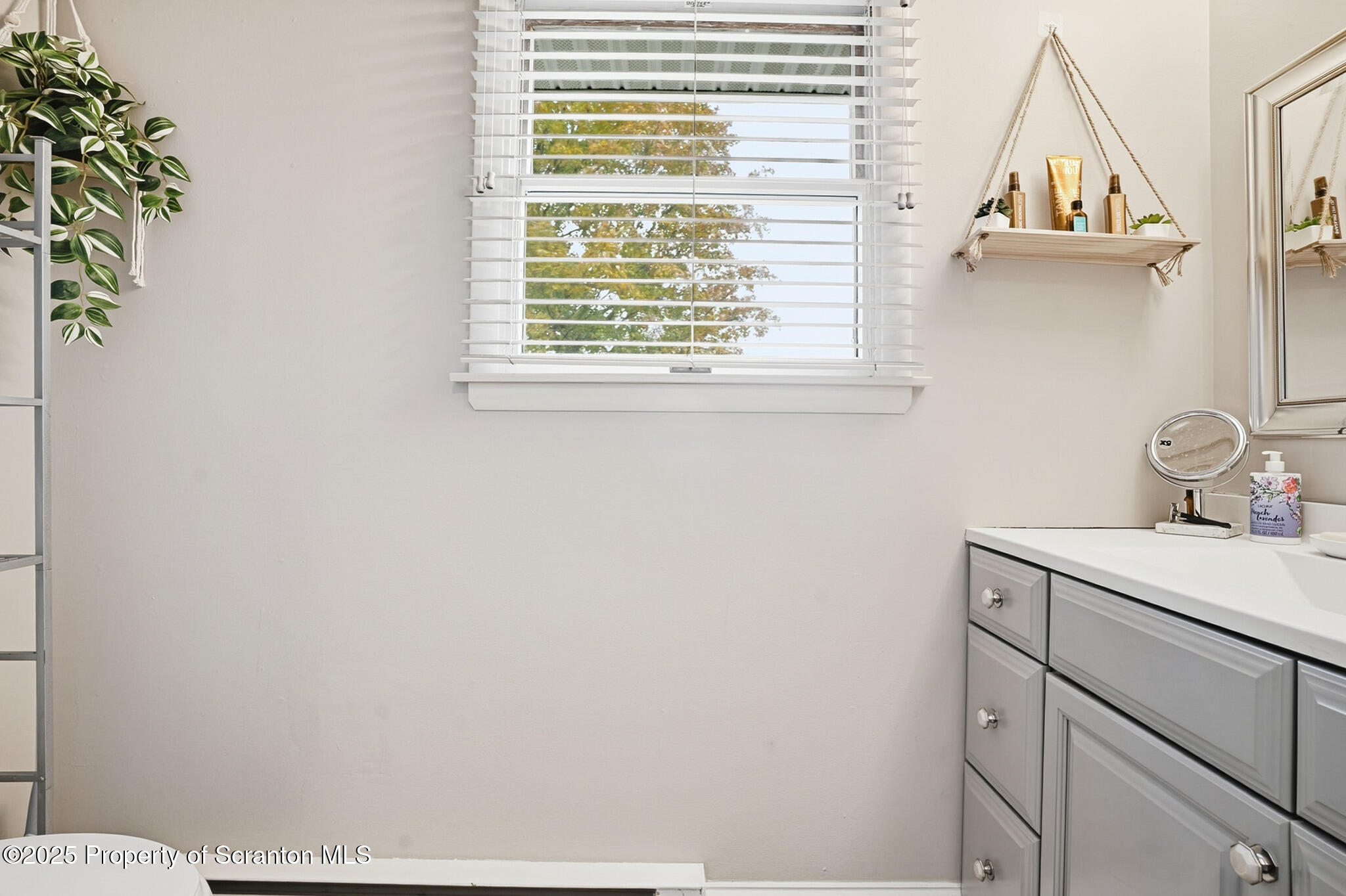 105 Fern Way Clarks Summit, PA 18411 - Photo 22 of 40 a bathroom with a sink a vanity and a window