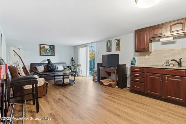 a living room with furniture flat screen tv and fireplace