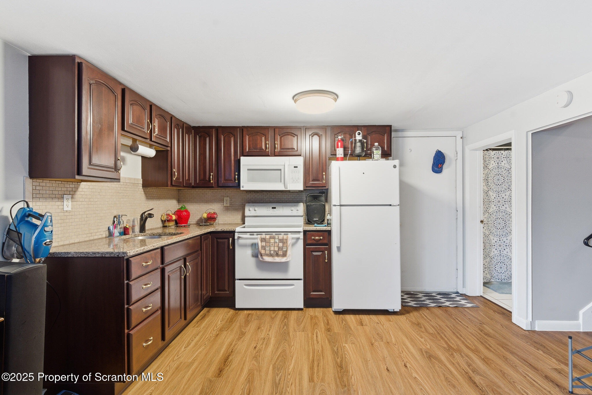 105 Fern Way Clarks Summit, PA 18411 - Photo 26 of 40 a kitchen with granite countertop a refrigerator stove top oven and sink