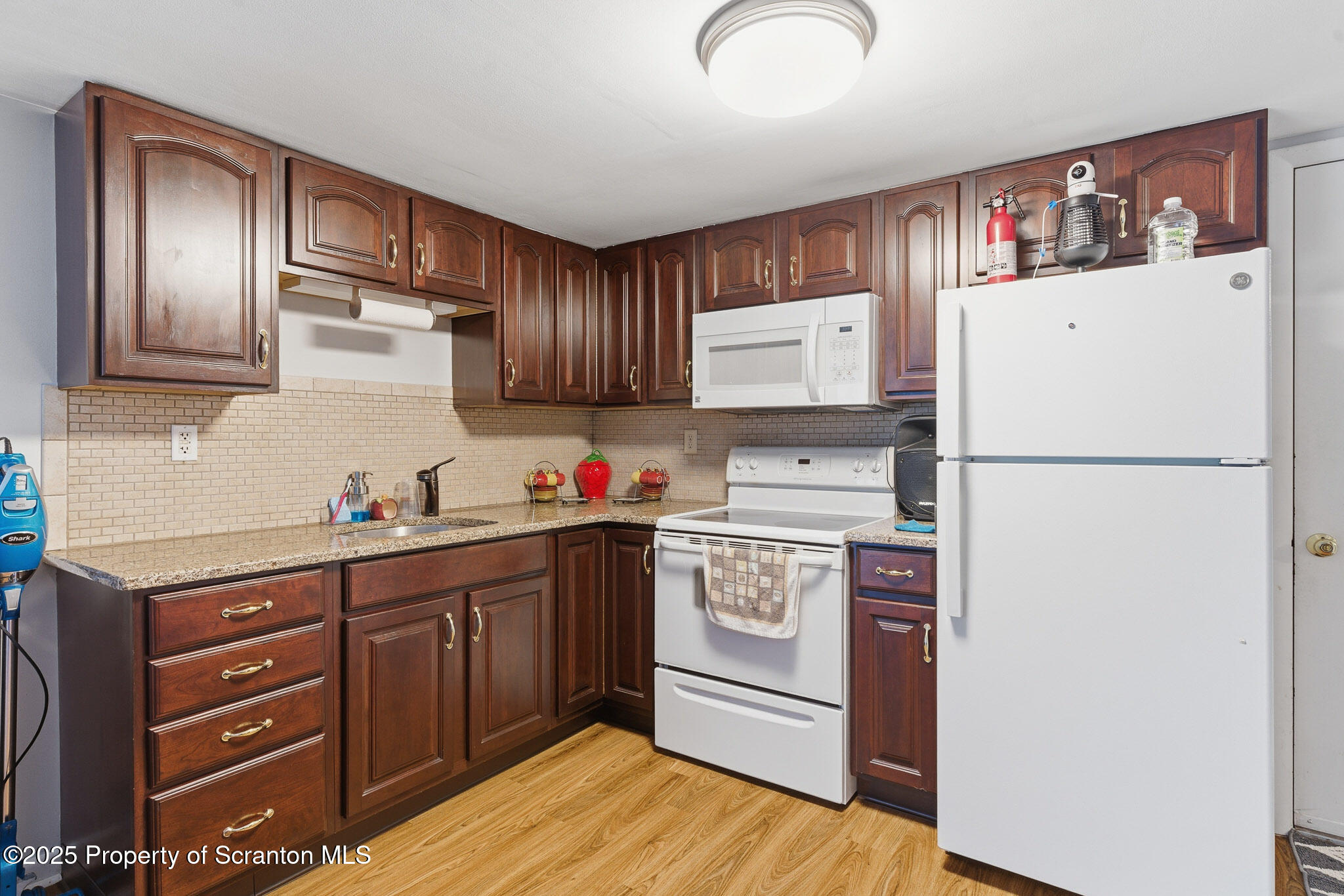 105 Fern Way Clarks Summit, PA 18411 - Photo 27 of 40 a kitchen with stainless steel appliances granite countertop a refrigerator sink and cabinets