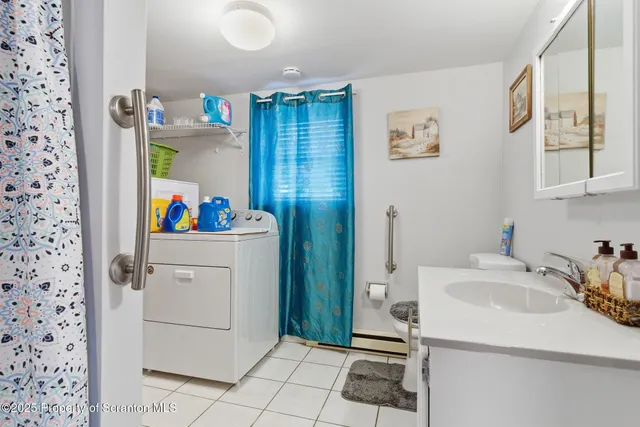 a utility room with cabinets washer and dryer